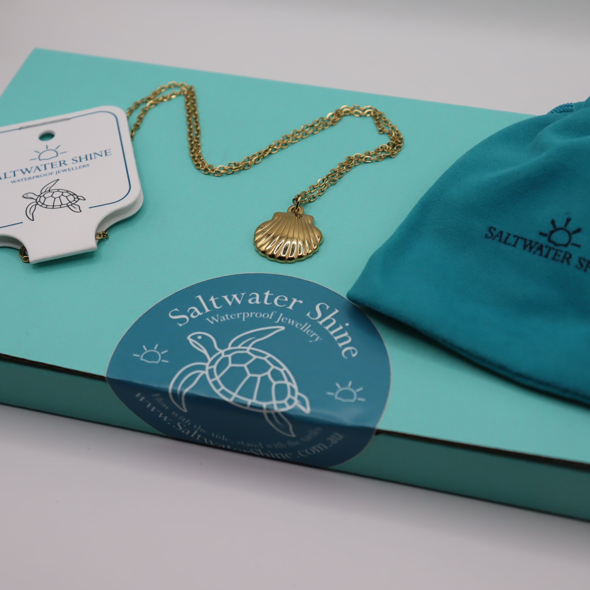 Gold necklace with shell pendant on a Saltwater Shine branded teal box