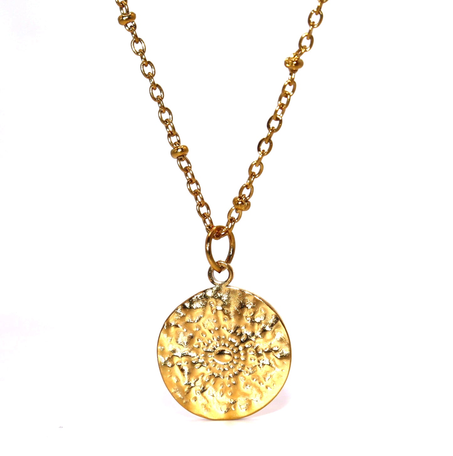 Gold necklace with a textured round pendant on a white background