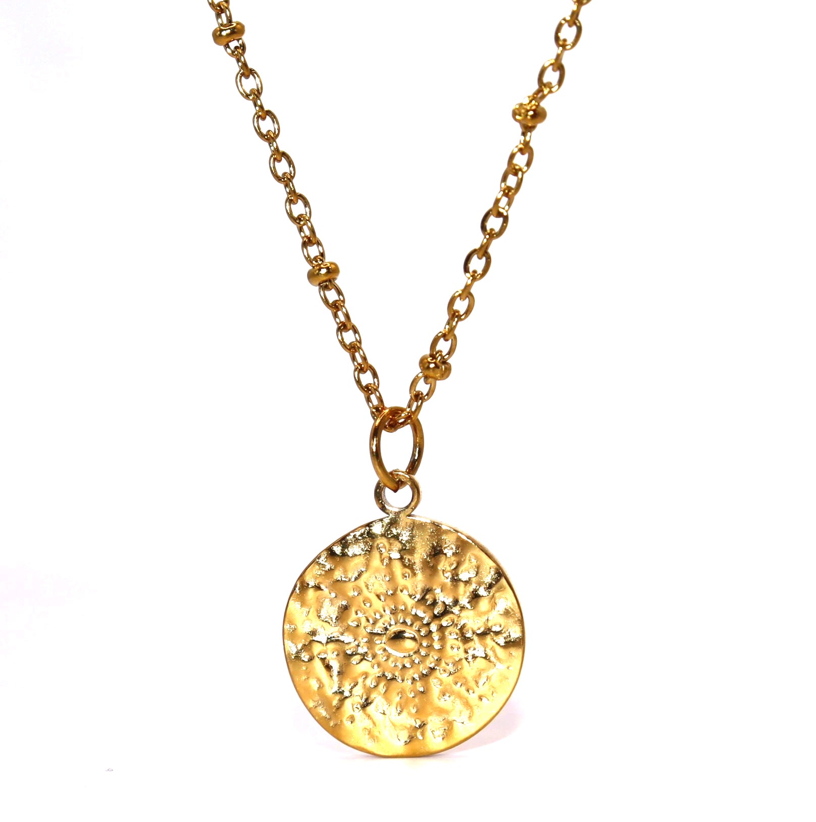 Gold necklace with a textured round pendant on a white background