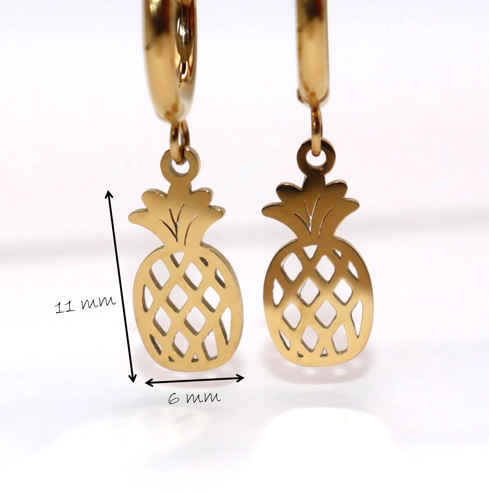 Gold pineapple earrings with measurements on a white background