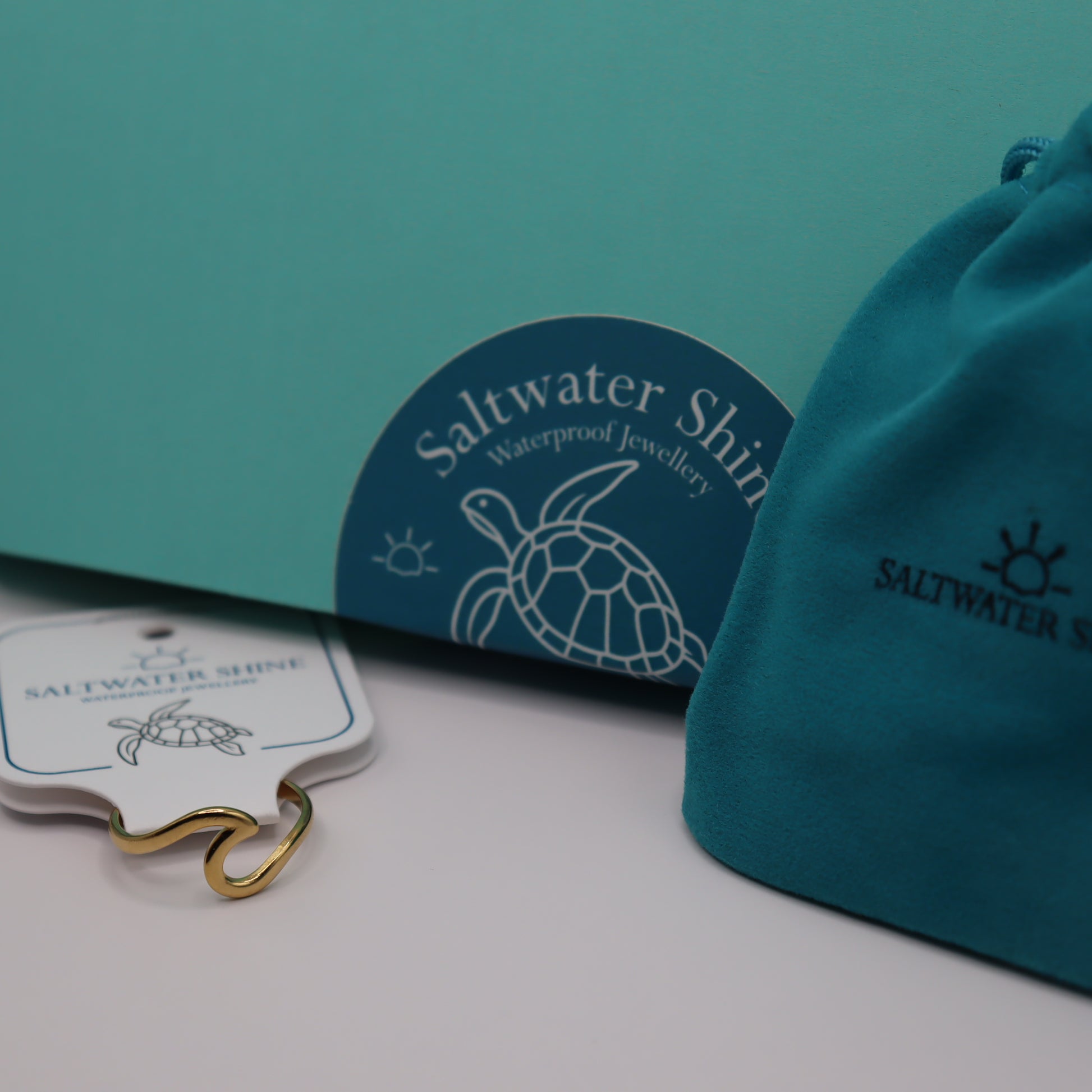 Saltwater Shine jewelry packaging with a turtle design on a white background